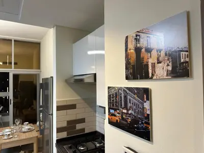 a kitchen with two pictures hanging on the wall at Dubai 7 in Dubai