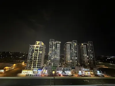 a city skyline at night with tall buildings at Dubai 7 in Dubai