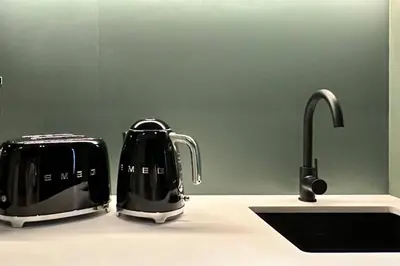 two toasters sitting on a kitchen counter next to a sink at Houzzze #4 DesignStudio Burj Khalifa view in Dubai