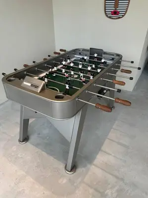 a ping pong table sitting in a room at Houzzze #4 DesignStudio Burj Khalifa view in Dubai