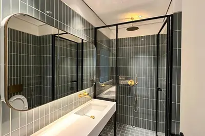a bathroom with a sink and a mirror and a tub at Houzzze #4 DesignStudio Burj Khalifa view in Dubai