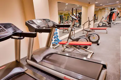 a gym with cardio machines and exercise bikes at Signature Hotel Al Barsha in Dubai
