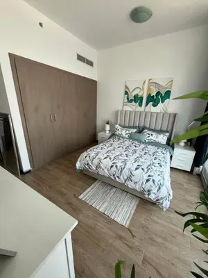 a bedroom with a large bed and a wooden floor at Specious cosy bedroom in Al Sufouh in Dubai