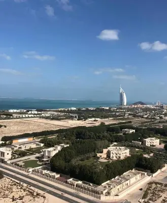 an aerial view of a city with a tall building at Specious cosy bedroom in Al Sufouh in Dubai