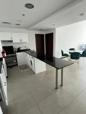 a kitchen with a table and chairs in a room at Specious cosy bedroom in Al Sufouh in Dubai