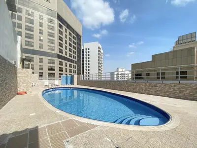 a large swimming pool in the middle of a building at Silkhaus High Floor 1 BDR with Metro Nearby in Dubai