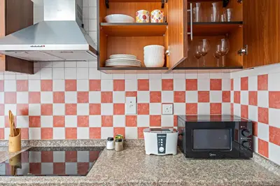 a kitchen counter with a microwave and a stove at Silkhaus High Floor 1 BDR with Metro Nearby in Dubai