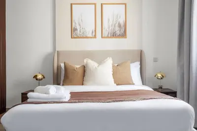 a bedroom with a large white bed with pillows at Silkhaus Metro Close To Barsha Heights in Dubai