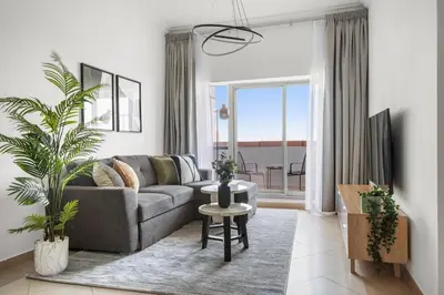 a living room with a couch and a table at Silkhaus Metro Close To Barsha Heights in Dubai