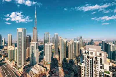 an aerial view of a city with a tall skyscraper at 2BR High Floor Infinity Pool w/ Burj Khalifa view in Dubai