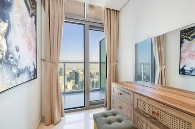 a living room with a large window with views of the city at 2BR High Floor Infinity Pool w/ Burj Khalifa view in Dubai