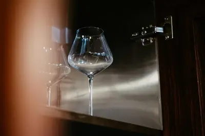 two empty wine glasses sitting on a shelf at Dubai Marina Delight: Spacious Retreat for Groups in Dubai