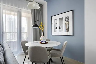 a dining room with a white table and chairs at Silkhaus Modern 1 BDR With Easy Access to Downtown in Dubai