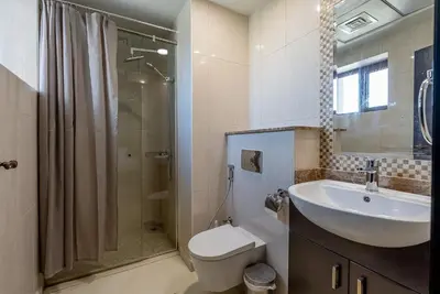 a bathroom with a sink and a toilet and a shower at Balqis Residences I Spacious and Modern 4BDR I Palm Jumeirah in Dubai
