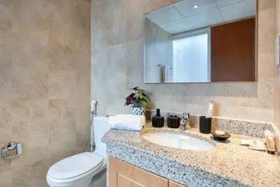 a bathroom with a sink and a toilet and a mirror at Exclusive 2BR Apartment in Madison Residency - Close to Dubai Internet City Metro Station in Dubai