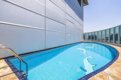 a swimming pool in the middle of a building at Exclusive 2BR Apartment in Madison Residency - Close to Dubai Internet City Metro Station in Dubai