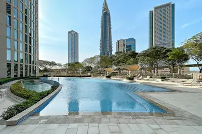 a swimming pool in a city with tall buildings at Luxury 1BR Skyline & Sea Views Walk to Dubai Mall & Burj Khalifa in Dubai