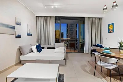 a living room with a couch and a table at Luxury 1BR Skyline & Sea Views Walk to Dubai Mall & Burj Khalifa in Dubai