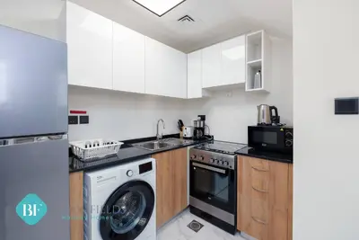 a kitchen with a washing machine and a washer at Bloomfields Premium 1br Duplex In Rukan in Dubai