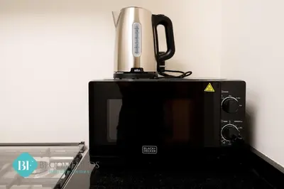 a coffee pot sitting on top of a microwave at Bloomfields Premium 1br Duplex In Rukan in Dubai