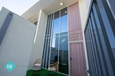 a balcony with chairs and a door in a building at Bloomfields Premium 1br Duplex In Rukan in Dubai