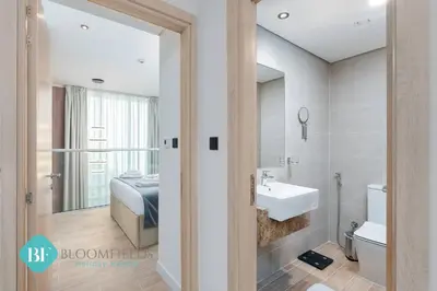 a bathroom with a sink and a bed at Bloomfields Premium 1br Duplex In Rukan in Dubai