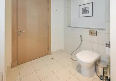 a bathroom with a toilet and a shower stall at Savis Homes - Damac Paramount Tower A 1BR Ultimate Luxury and Glam Escape in Dubai