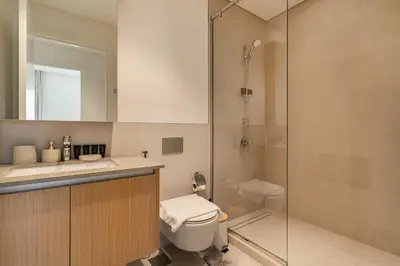 a bathroom with a shower and a toilet and a sink at Spacious 1-Bedroom in Summer, Lagoon Access Feature - Allsopp&Allsopp in Dubai