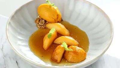 a white bowl filled with carrots in a sauce at InterContinental Residences Dubai Business Bay by IHG in Dubai