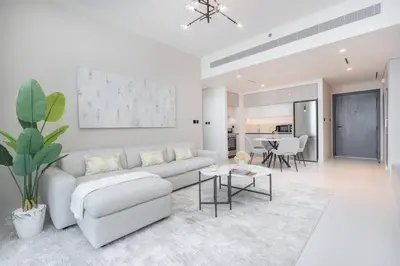 a white living room with a couch and a table at Czechin * Brand New * BeachFront * Palm View * High Floor in Dubai
