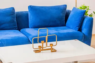 a blue couch with a coffee table in front of it at Sound of the Waves in JBR by Lagom in Dubai