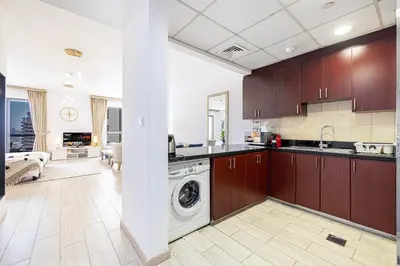 a kitchen with a washer and dryer in it at Sound of the Waves in JBR by Lagom in Dubai