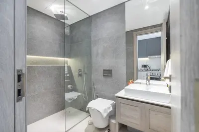 a bathroom with a toilet and a sink and a shower at New Listing * Pool & Marina Skyline View * TOP Amenities in Dubai