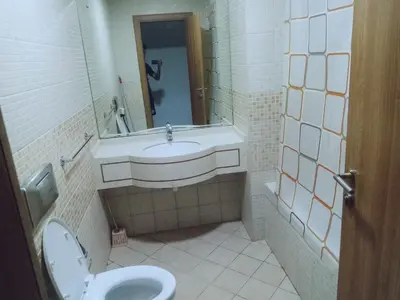 a bathroom with a toilet and a sink and a mirror at luxury master room available in sulafa tower marina in Dubai