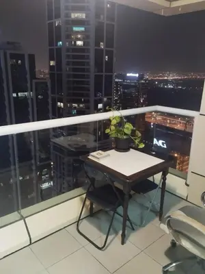 a table with a potted plant on top of a balcony at luxury master room available in sulafa tower marina in Dubai