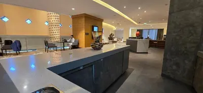 a large lobby with a counter and chairs in a building at The Star in Dubai