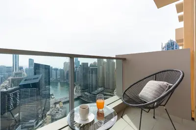 a balcony with a table and chair and a view of the city at The Star in Dubai