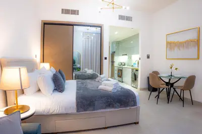 a bedroom with a large bed and a table with chairs at Dubai Skyline Retreat with Burj Khalifa View in Dubai