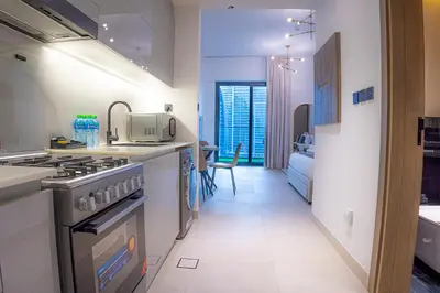 a kitchen with a sink and a stove top oven at Dubai Skyline Retreat with Burj Khalifa View in Dubai