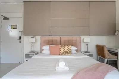 a bedroom with a large white bed with a white scale on it at GuestReady - Maison Vogue Studio Business Bay in Dubai