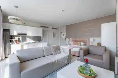 a living room with a couch and a table at GuestReady - Maison Vogue Studio Business Bay in Dubai