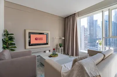 a living room with a couch and a tv at GuestReady - Maison Vogue Studio Business Bay in Dubai
