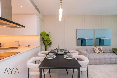 a living room with a black table and chairs at Beachfront Bliss 2BR Dubai Eye & Full Sea View at the Address Beach By ĀYA Boutique in Dubai
