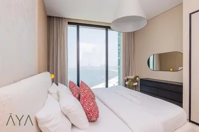 a bedroom with a bed with pillows and a window at Beachfront Bliss 2BR Dubai Eye & Full Sea View at the Address Beach By ĀYA Boutique in Dubai