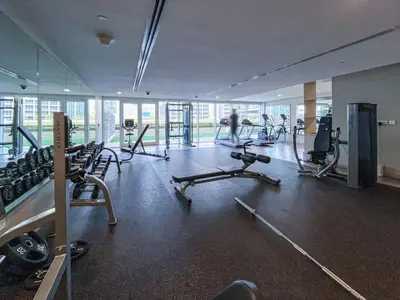 a gym with several treadmills and exercise bikes at 1 Bedroom Business Bay Bliss with a Canal View in Dubai