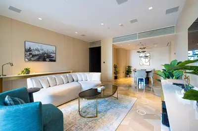 a living room with a large couch and a table at FIVE Palm Luxury 1BR Apartment with Stunning Views in Dubai