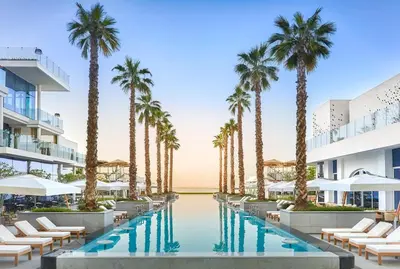 an image of a resort pool with palm trees at FIVE Palm Luxury 1BR Apartment with Stunning Views in Dubai