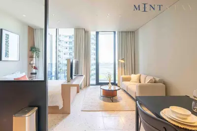 a living room with a couch and a table at Upside Living, Business Bay Dubai - Mint Stay in Dubai