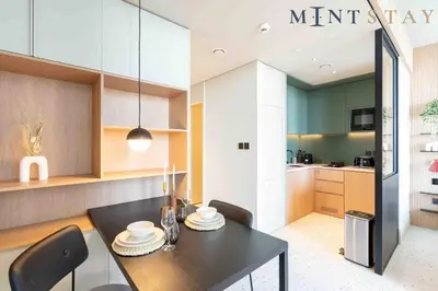 a kitchen and dining room with a table and chairs at Upside Living, Business Bay Dubai - Mint Stay in Dubai