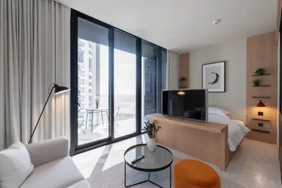 a living room with a tv and a bed and a couch at Upside Living, Business Bay Dubai - Mint Stay in Dubai